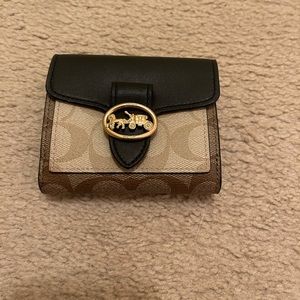 A Coach brand brown and tan wallet